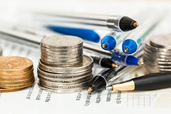 Geld und Kugelschreiber liegen auf einem Notizblock